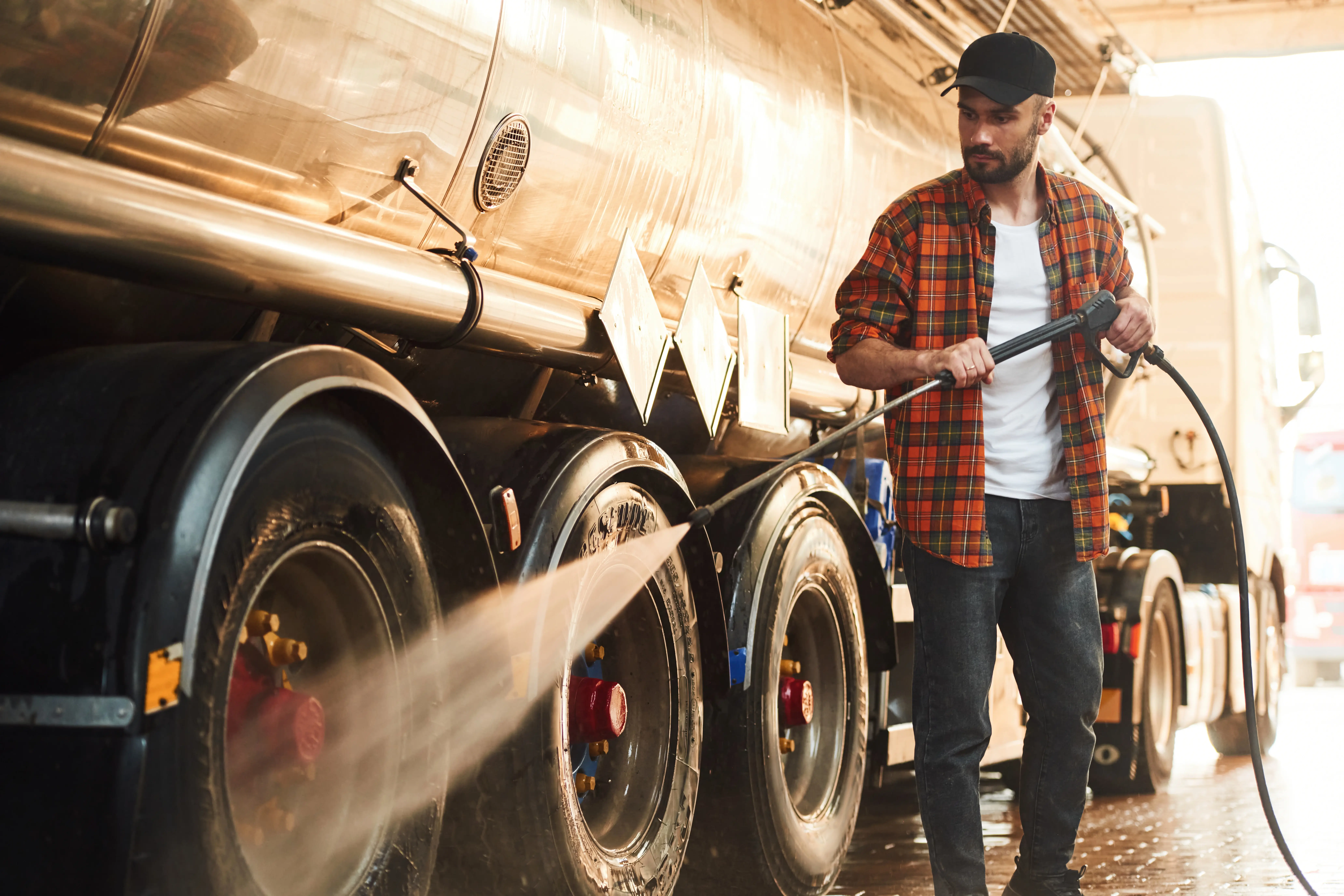 Diesel Mechanic in Caddo Mills TX washing the truck wheel